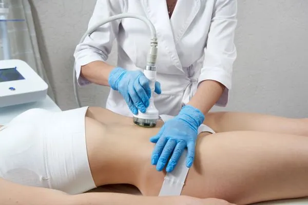 Lost the Weight but Not the Loose Skin? 2 woman having HIFU treatment on her stomach to combat loose skin Ely following weight loss